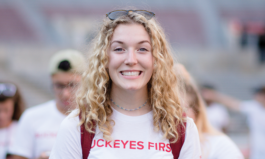 A female student celebrating Welcome Week in Ohio Stadium