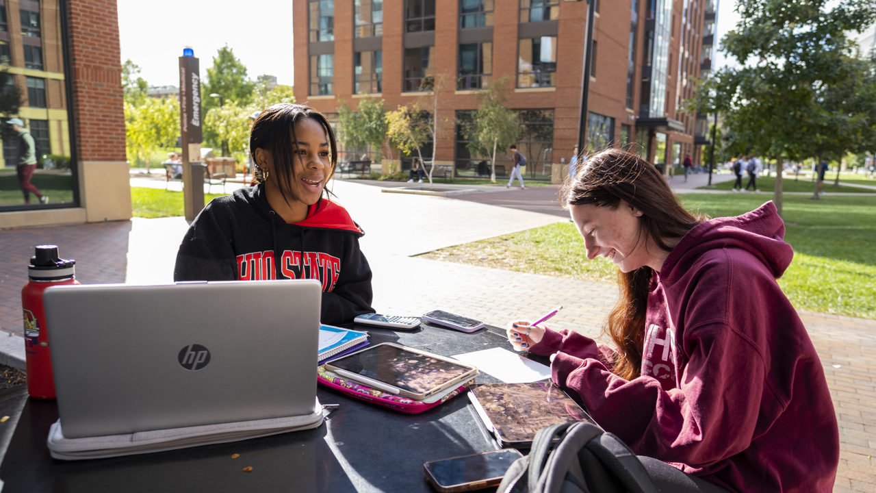 Two students outside working together
