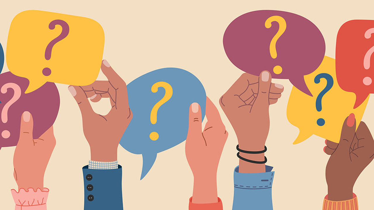 Hands raised and holding question marks